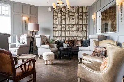 a living room with couches and chairs at The Gannet Inn in St Ives