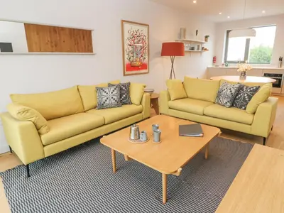 a living room with two couches and a coffee table at Villa 80 in St Ives