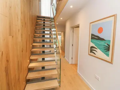 a spiral staircase in a house with wooden walls at Villa 80 in St Ives