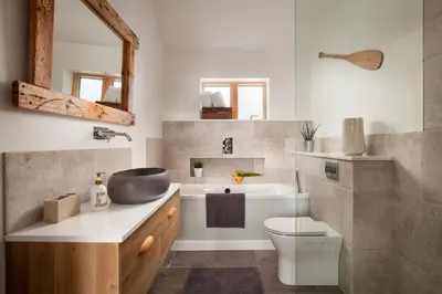 a bathroom with a sink and a toilet at Songbirds in Bude