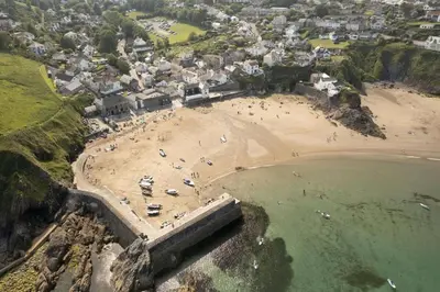 an aerial view of a beach with a group of people at Gorgeous Cottage Parking Short Walk to Beach in Gorran Haven
