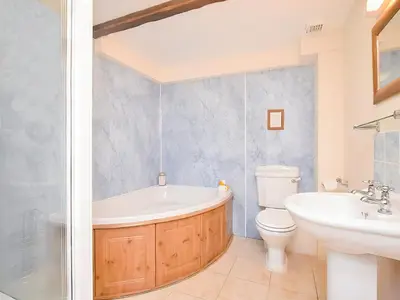 a bathroom with a tub and a toilet and a sink at Bill And Ben's Cottage - Uk48619 in Warbstow