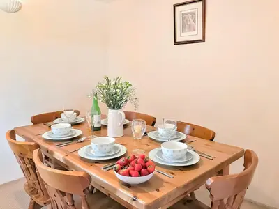a wooden table with a bowl of fruit on it at Bill And Ben's Cottage - Uk48619 in Warbstow