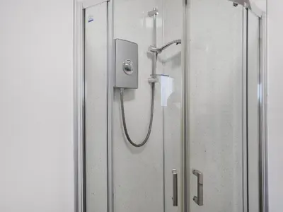 a shower in a bathroom with a glass door at Pencarrow in Fowey
