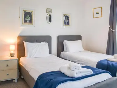 a bedroom with two beds with towels on them at Pencarrow in Fowey