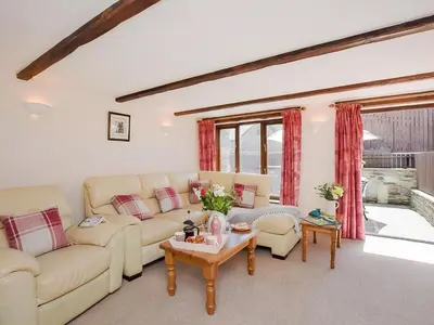 a living room with couches and a table at Grandma's Cottage - Uk48618 in Warbstow