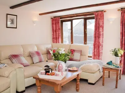 a living room with a couch and a table at Grandma's Cottage - Uk48618 in Warbstow