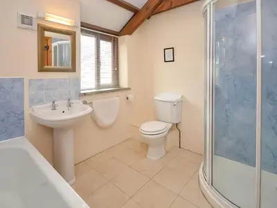 a bathroom with a toilet and a sink and a shower at Grandma's Cottage - Uk48618 in Warbstow