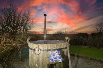 a wooden barrel with a water fountain with a sky at Smugglers in Bodmin