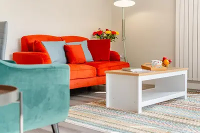 a living room with an orange couch and a coffee table at 1 Bed in Tresillian oc-p30116 in Saint Clement