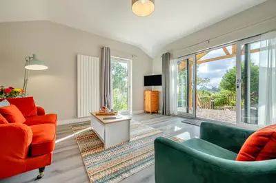 a living room with two chairs and a table at 1 Bed in Tresillian oc-p30116 in Saint Clement