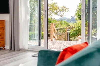 a living room with an open door to a garden at 1 Bed in Tresillian oc-p30116 in Saint Clement
