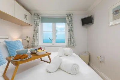 a room with a bed with a tray of food on it at Ocean View in Carbis Bay
