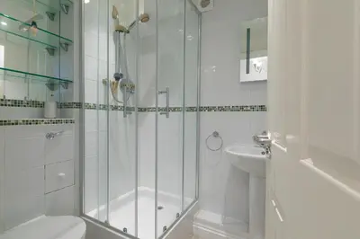 a bathroom with a shower and a toilet and a sink at Ocean View in Carbis Bay