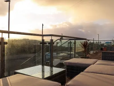 a balcony with a view of the water at 5 Fistral Waves in Newquay