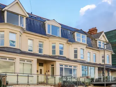 a large yellow house with a lot of windows at 5 Fistral Waves in Newquay