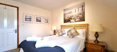 a bedroom with a bed with two pillows at 15 Penhale, Perranporth in Perranporth