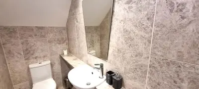 a bathroom with a toilet and a sink at 15 Penhale, Perranporth in Perranporth