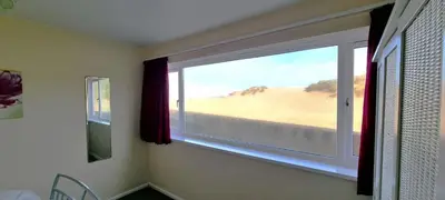 a window in a room with a view of the desert at Sand Bay, Perranporth in Perranporth