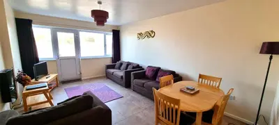 a living room with a couch and a table at Sand Bay, Perranporth in Perranporth