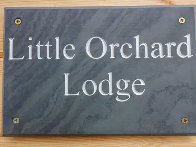 a sign that reads little orchard lodge at Little Orchard Lodge in Truro
