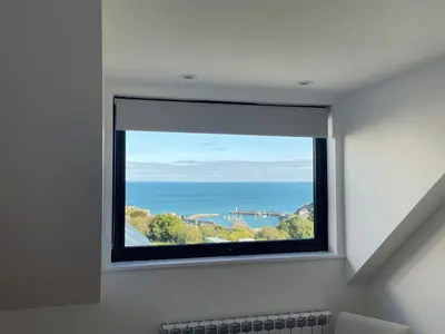 a window in a room with a view of the ocean at Mayflower in St Austell