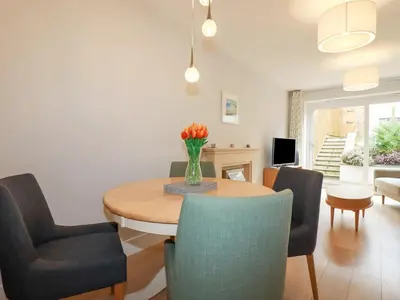 a living room with a table and chairs at Luxury 3-Bed house, Beach 300m, Sleeps 6, Parking in Newquay