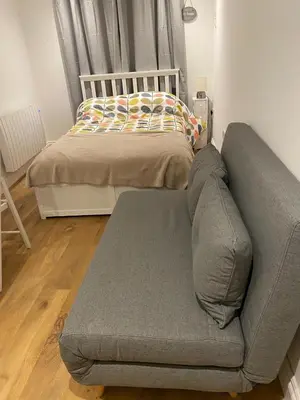 a couch in a living room with a bed at Seaside Cabin Perranporth in Perranporth