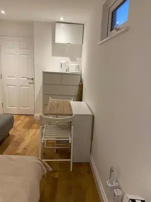 a small kitchen with a table in a room at Seaside Cabin Perranporth in Perranporth