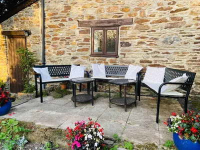 a group of chairs and a table in front of a building at Cornish country house by the coast near Fowey in Lanteglos