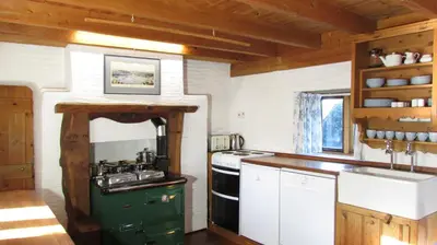 a kitchen with a stove and a sink at Cornish country house by the coast near Fowey in Lanteglos