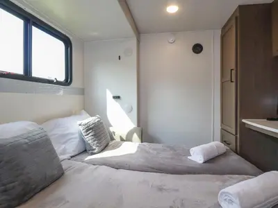 a small bedroom with a bed and a window at Tickeydoo, Tor Down Quarry in Bodmin