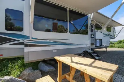 an rv with a picnic table in front of it at Tickeydoo, Tor Down Quarry in Bodmin