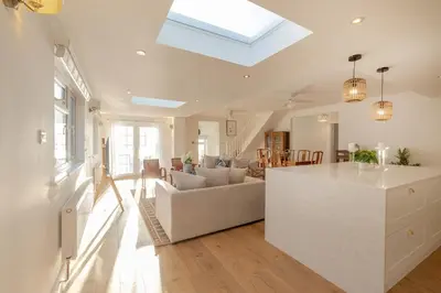 a kitchen and living room with a skylight at Luxury Cornish Seaview Bungalow in Looe