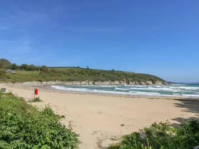 a beach with a red object in the sand at Freesia in Truro