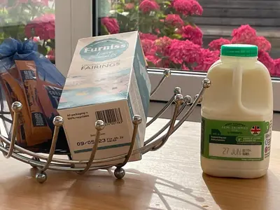 a cart with a gallon of milk and a box of food at Sea Spray in Port Isaac
