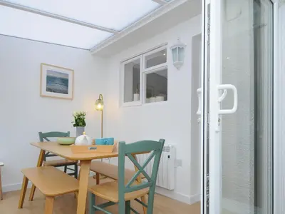 a dining room with a table and chairs at Sea Spray in Port Isaac