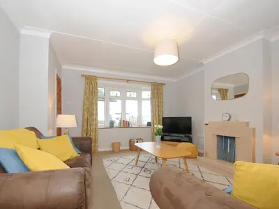 a living room with a couch and a tv at Sea Spray in Port Isaac