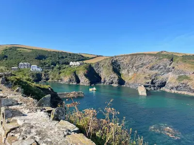 a river with a boat in a body of water at Sea Spray in Port Isaac