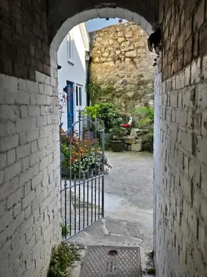 an archway in an alley with a gate at 4 Tre Pol Pen, and the Wash Kitchen in St Ives