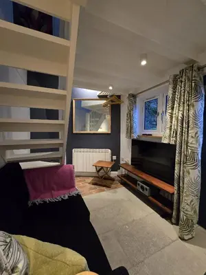 a living room with a couch and a television at 4 Tre Pol Pen, and the Wash Kitchen in St Ives