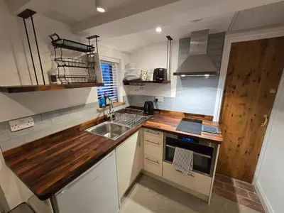 a kitchen with a wooden counter top and a sink at 4 Tre Pol Pen, and the Wash Kitchen in St Ives