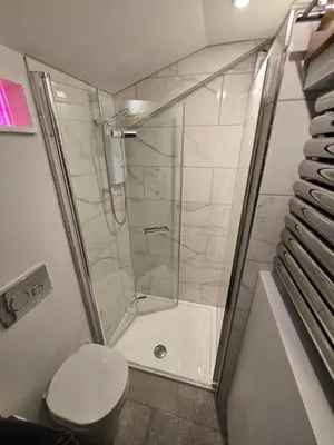 a bathroom with a shower and a toilet at 4 Tre Pol Pen, and the Wash Kitchen in St Ives
