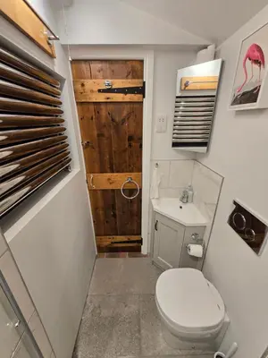 a bathroom with a toilet and a sink at 4 Tre Pol Pen, and the Wash Kitchen in St Ives