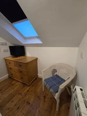a bedroom with a bed and a dresser and a window at 4 Tre Pol Pen, and the Wash Kitchen in St Ives