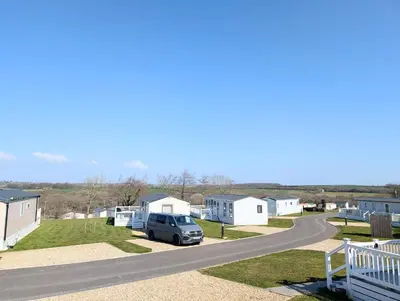 a view of a road with houses and a car parked at Wallows Lodge with private hot tub in St Austell