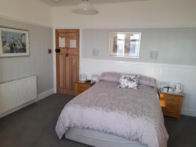 a bedroom with a bed with a pillow on it at Wild Air Guest House in Mevagissey
