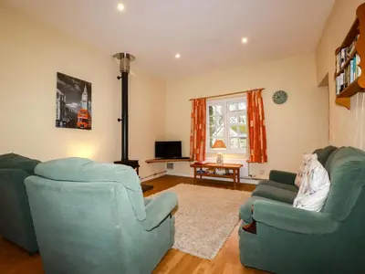 a living room with two chairs and a couch at The Coach House in Camelford