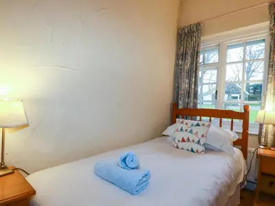a bedroom with a bed with towels on it at The Smithy in Camelford