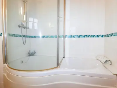 a bathroom with a shower and a tub at The Smithy in Camelford